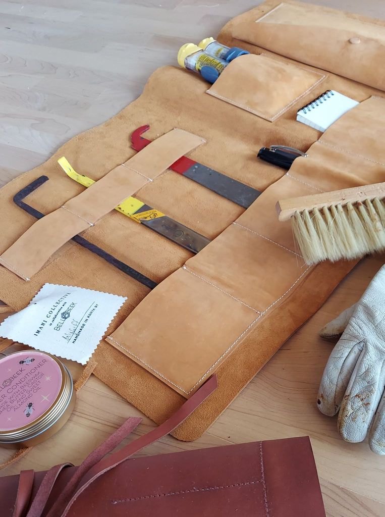 Leather tool pouch filled with beekeeping tools