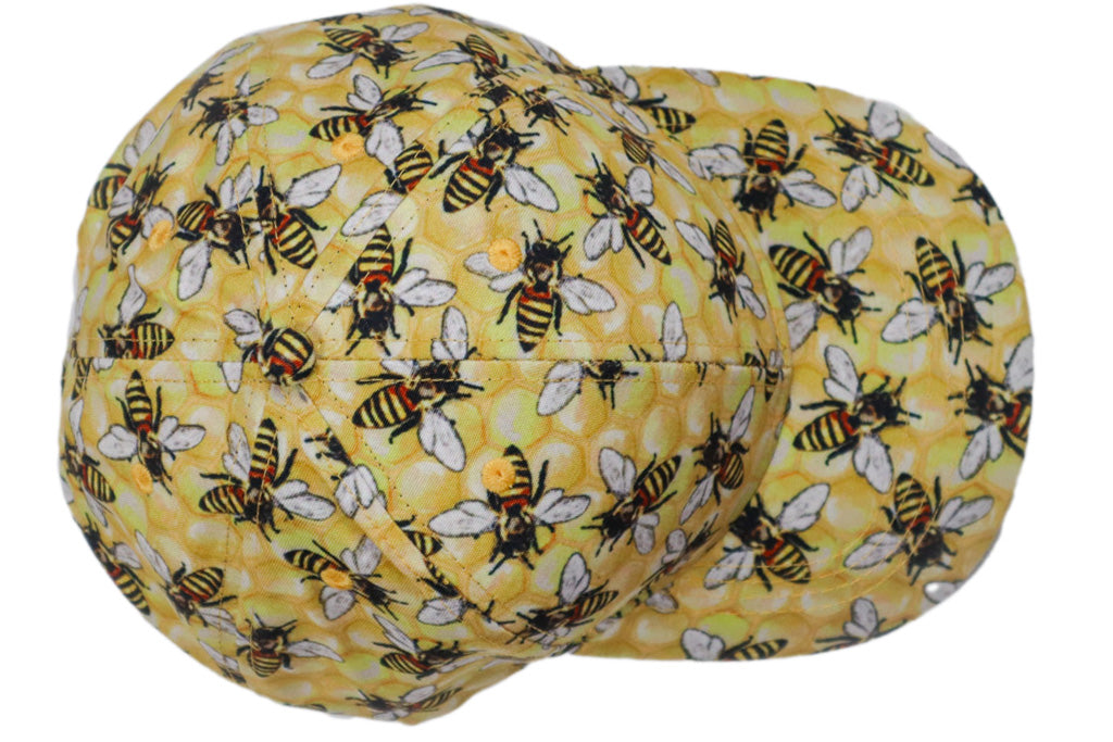 Baseball hat with yellow honeycomb background and large honeybees.