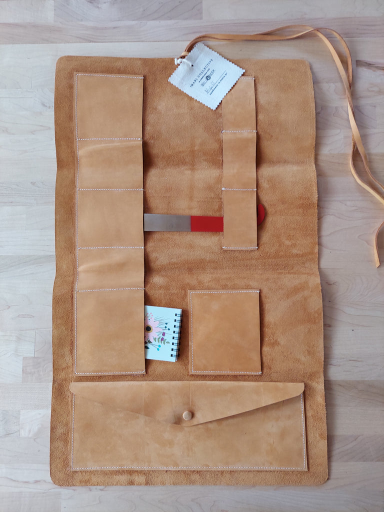 Leather tool roll made to store beekeeping tools.