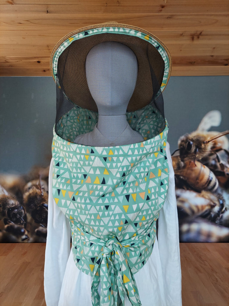 Light green and geometric shapes print women's beekeeper veil with brown and black sunhat.